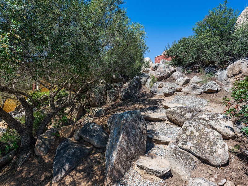 In den Felsen gehauen der Weg durch die Macchia zum Pool